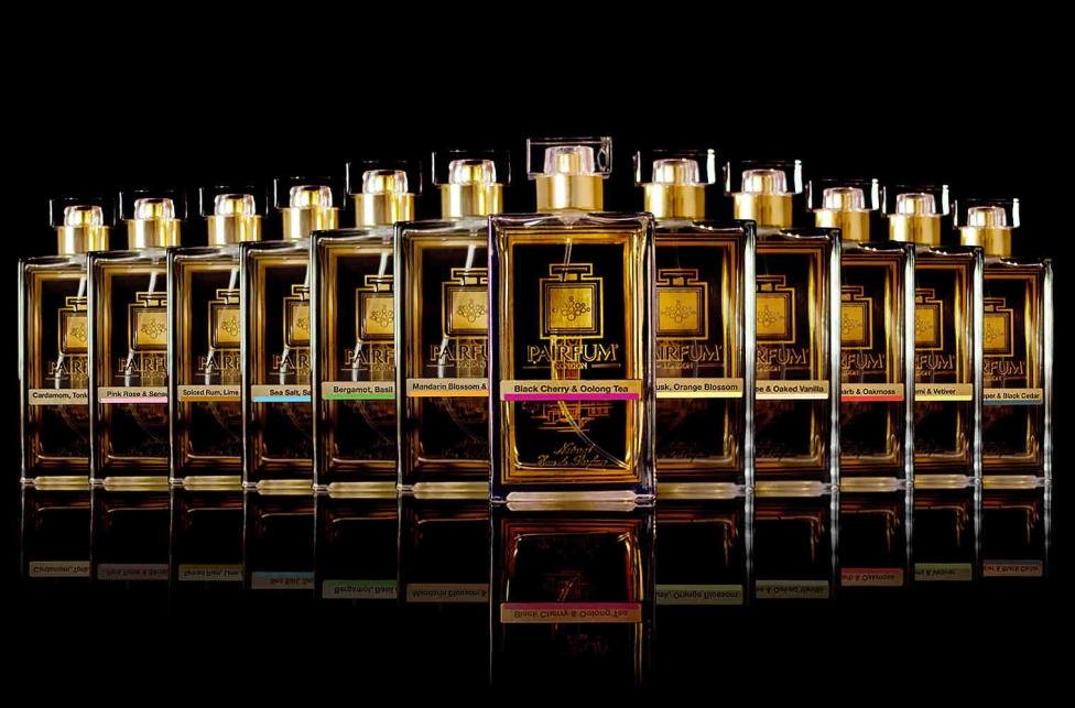 The twelve Pairfum London Eau de Parfum Intense bottles lined up on a black background