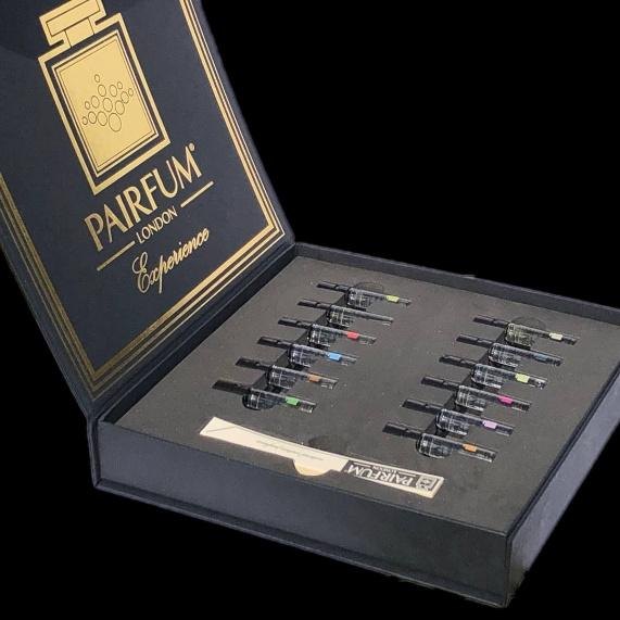 The Pairfum London Perfume Experience Box, open, showing a row of sample vials